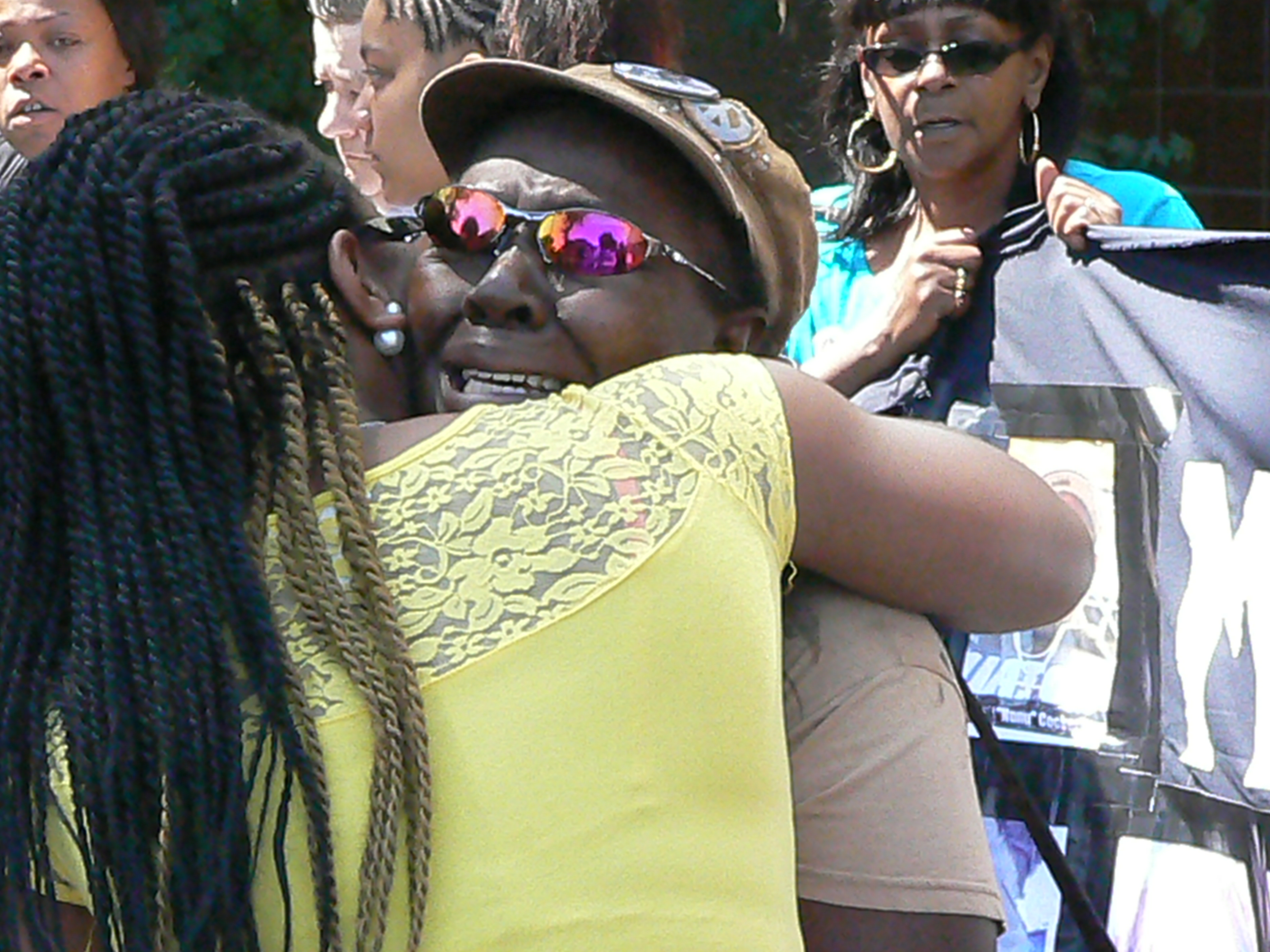 Mertilla Jones is comforted after describing how her 7-year-old granddaughter was killed by a white Detroit police officer.
