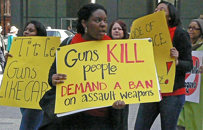 Marchers protest outside federal plaza in Chicago to demand tougher gun control legislation.