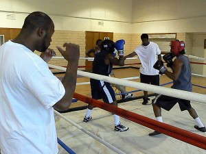 Standing just outside the boxing ring, coach Derek Brown watches with a critical eye as two young men spar.
