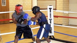 Two men spar in the ring at practice at North Lawndale Boxing League. Coach Derek Brown uses boxing to turn kids away from violence.